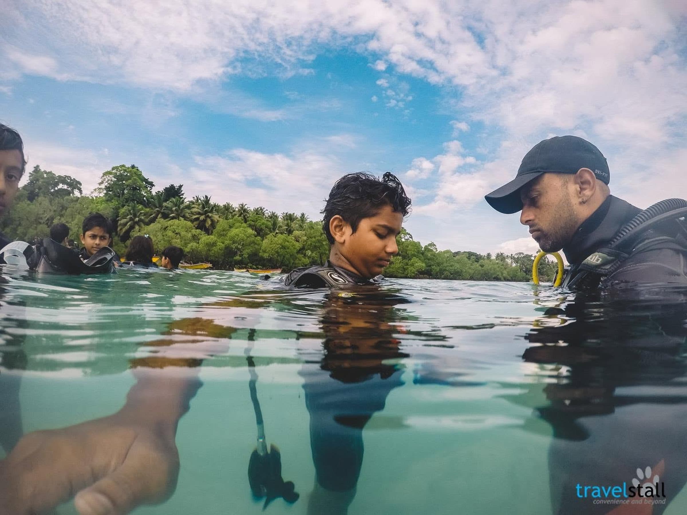 Students receiving scuba instruction during an environmental science tour